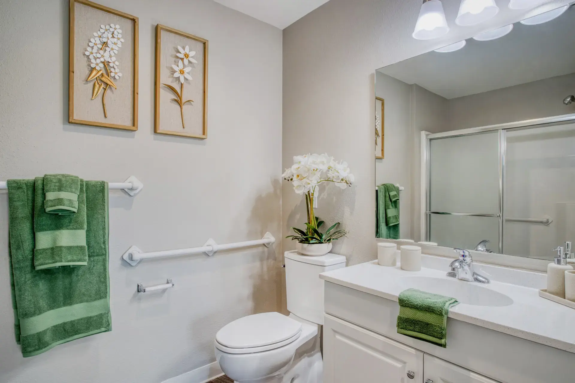Furnished Bathroom with towels hanging and floral decor. 